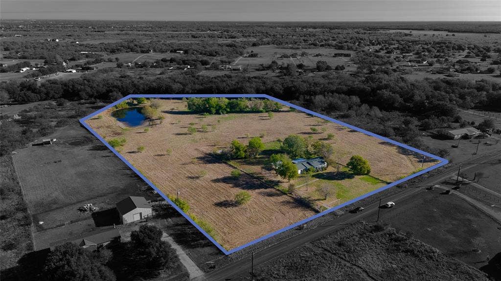 212 Old Wagon Road, Royse City, TX 75189 Expansive acreage featuring a private pond, mature trees, open pasture, and a detached outbuilding