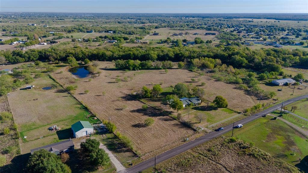 212 Old Wagon Road, Royse City, TX 75189 Expansive acreage featuring a private pond, mature trees, open pasture, and a detached metal-sided structure