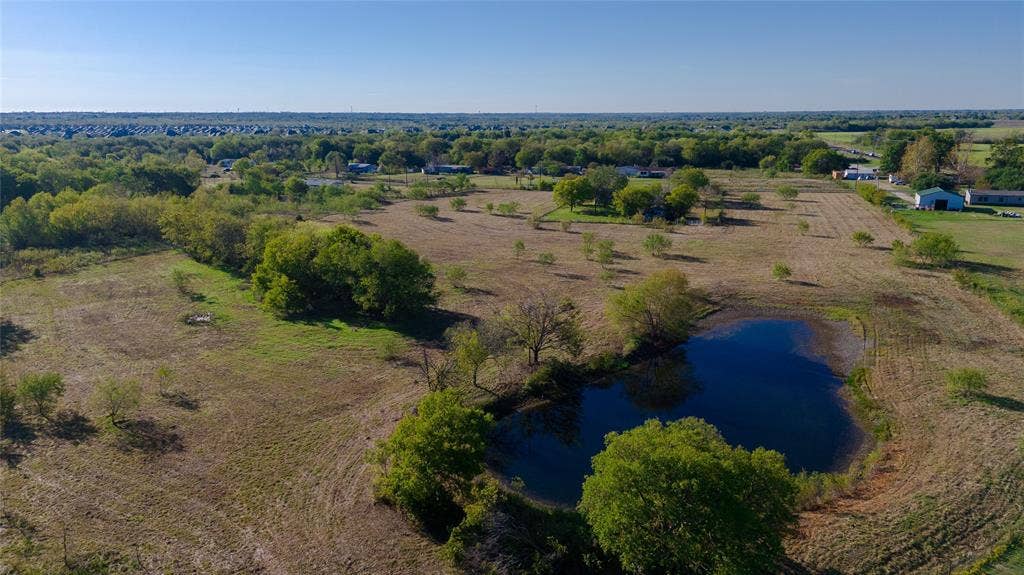 212 Old Wagon Road, Royse City, TX 75189 Expansive acreage featuring a private pond, mature trees, and open terrain