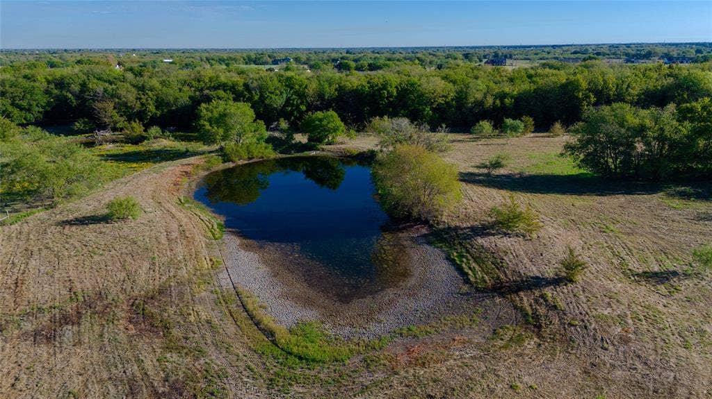 212 Old Wagon Road, Royse City, TX 75189 Expansive acreage featuring a private pond, mature trees, and open terrain