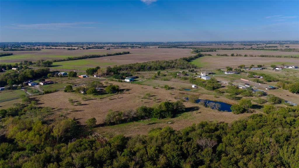 212 Old Wagon Road, Royse City, TX 75189 Expansive acreage featuring mature trees, open pasture, and a natural pond