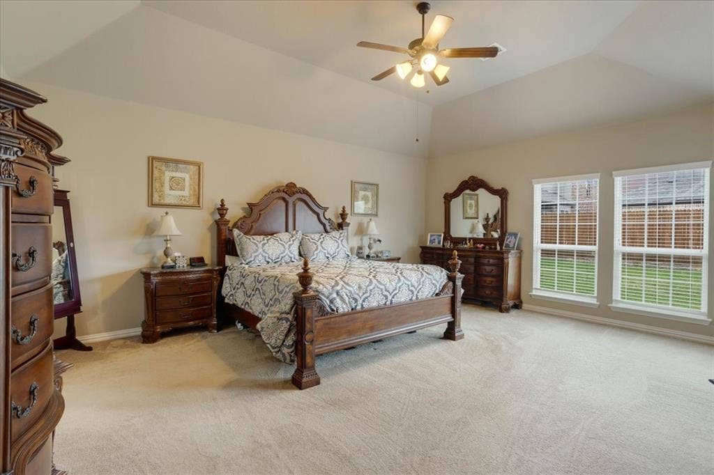 319 Westphalian Drive, Celina, TX 75009 Spacious room featuring vaulted ceilings, neutral-toned carpeting, and a ceiling fan with integrated lighting