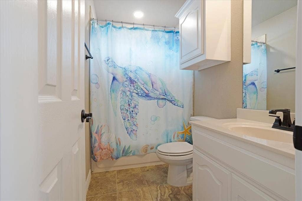 319 Westphalian Drive, Celina, TX 75009 Bathroom featuring a white vanity with integrated sink, a wall-mounted medicine cabinet, and a commode