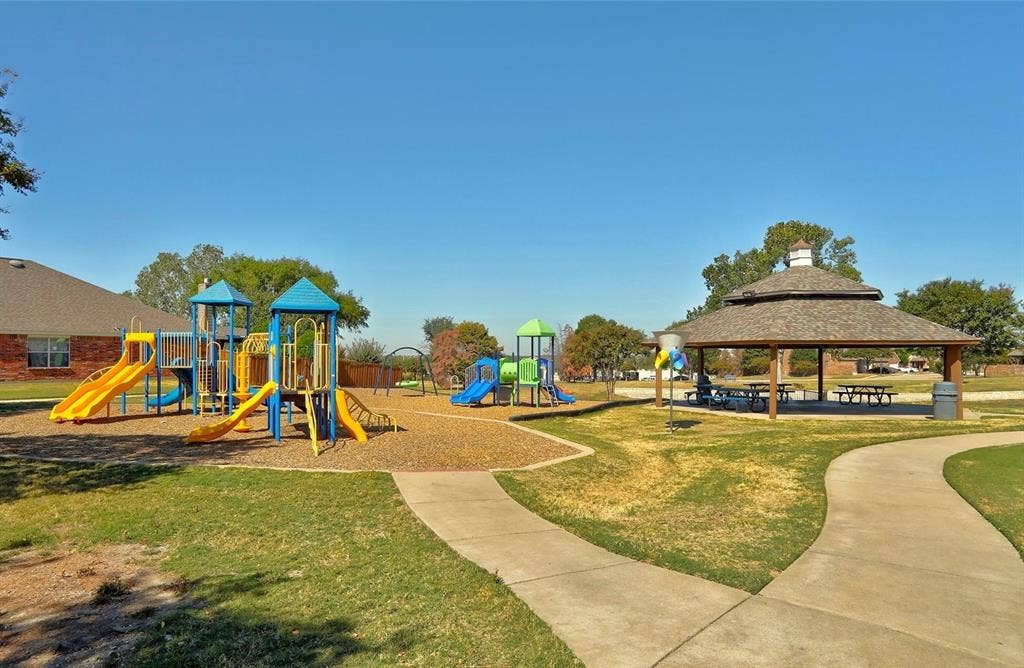 319 Westphalian Drive, Celina, TX 75009 Community park featuring a multi-level playground, covered gazebo with picnic tables, walking paths, and expansive grassy areas