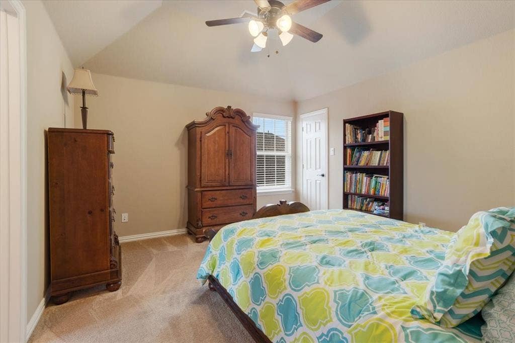 319 Westphalian Drive, Celina, TX 75009 Carpeted room featuring a ceiling fan with integrated lighting, a double-hung window with blinds, and a white paneled door