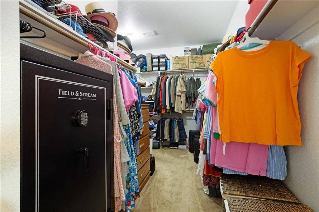 319 Westphalian Drive, Celina, TX 75009 Spacious walk-in closet featuring wood-finish flooring, built-in shelving, and multiple clothing rods