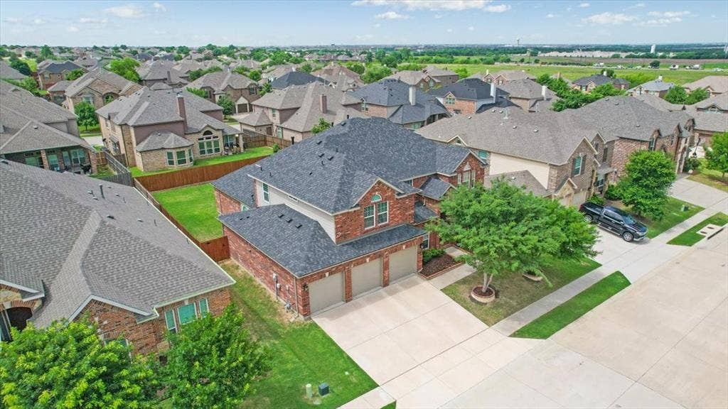 319 Westphalian Drive, Celina, TX 75009 Brick veneer exterior with a two-story design and a three-car garage