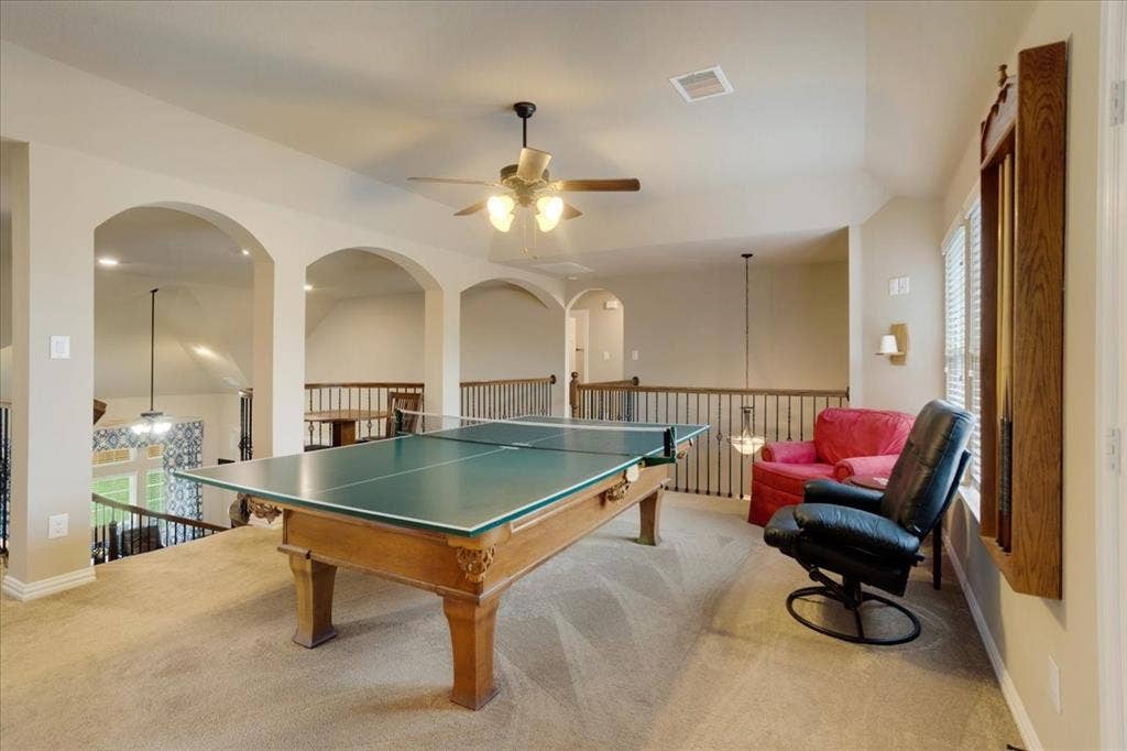 319 Westphalian Drive, Celina, TX 75009 Carpeted loft area featuring multiple arched openings, a ceiling fan with integrated lighting, recessed lighting, and a balustrade overlooking the level below