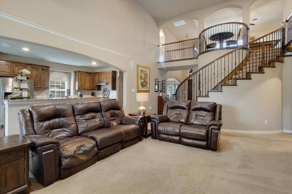319 Westphalian Drive, Celina, TX 75009 Grand foyer featuring a curved staircase with wrought iron balusters and wood handrails