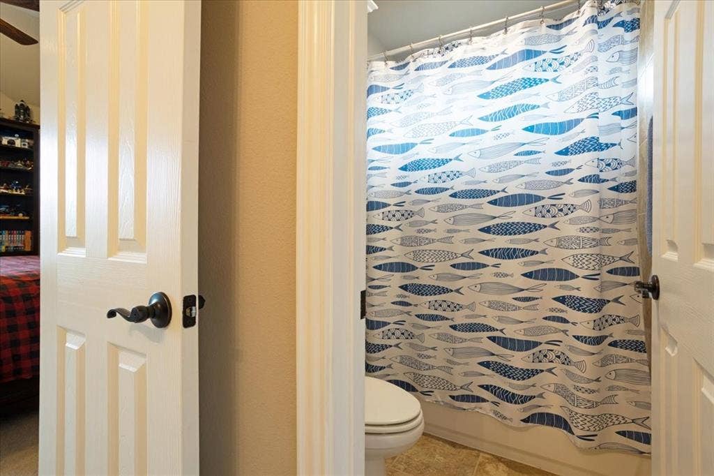 319 Westphalian Drive, Celina, TX 75009 Bathroom entry with white paneled doors and dark bronze hardware