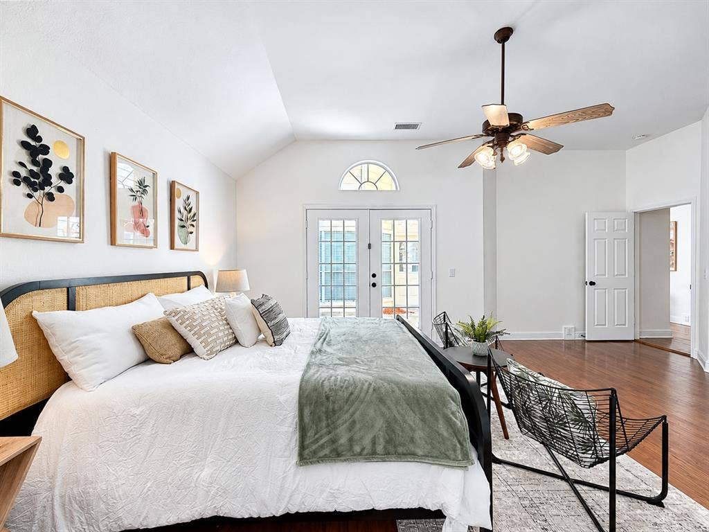 7514 Naples Lane, Frisco, TX 75035 Vaulted ceilings, wood-finish flooring, French doors with an arched transom window, and a multi-blade ceiling fan with integrated lighting