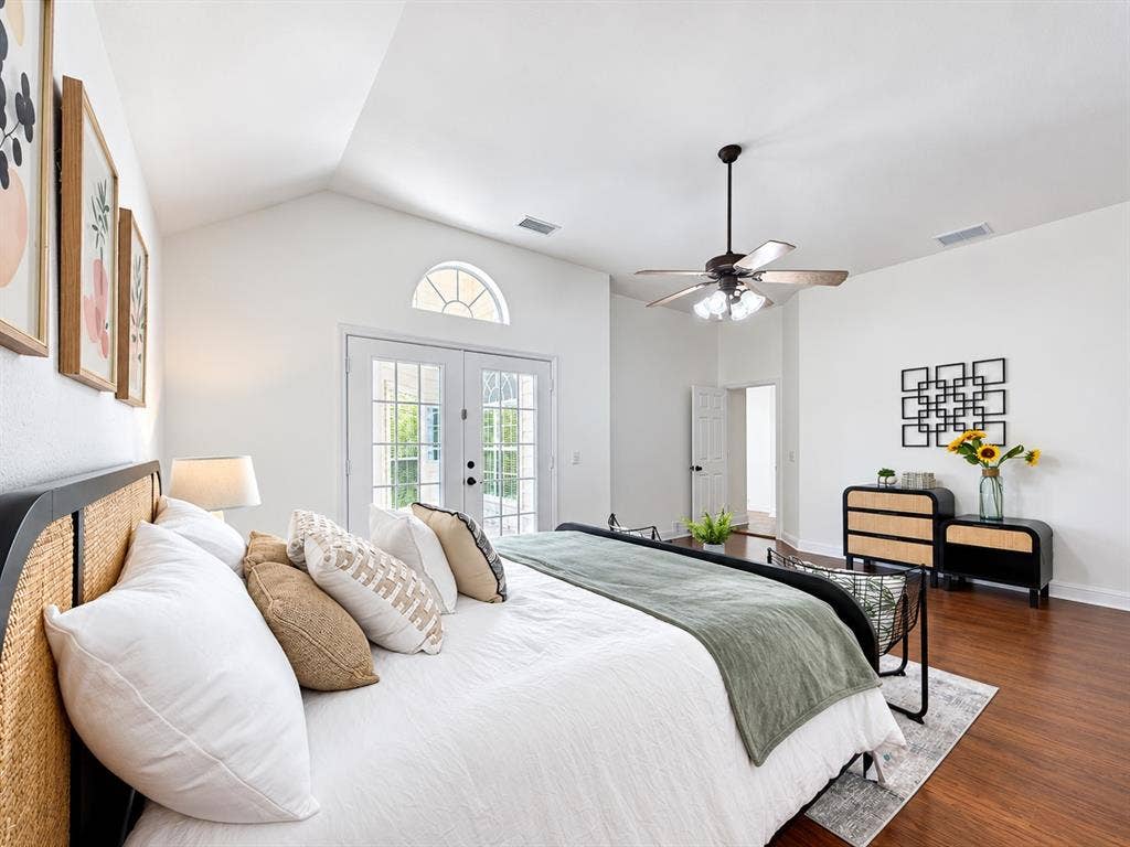 7514 Naples Lane, Frisco, TX 75035 Vaulted ceilings, wood-finish flooring, glass-paneled double doors with an arched transom, and a central ceiling fan with integrated lighting