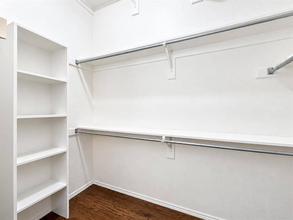 7514 Naples Lane, Frisco, TX 75035 Built-in vertical shelving unit with wood-finish flooring and tiered metal garment rods