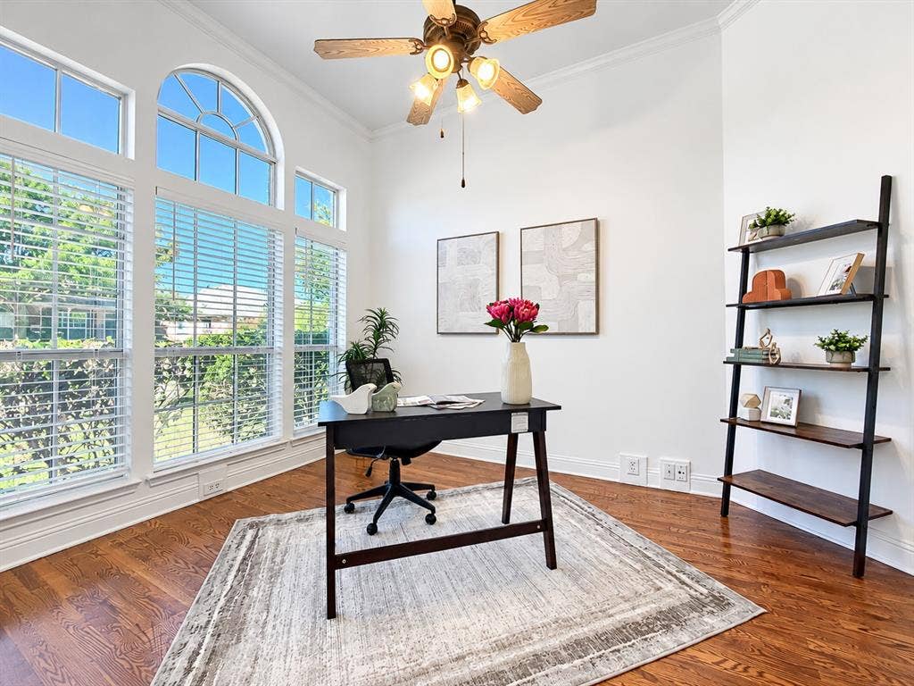 7514 Naples Lane, Frisco, TX 75035 Room featuring expansive arched windows, wood-finish flooring, and a multi-light ceiling fan