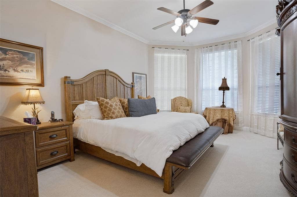 701 Crabapple Way, McKinney, TX 75072 Room featuring a bay window, ceiling fan with integrated lighting, neutral wall-to-wall carpeting, and crown molding