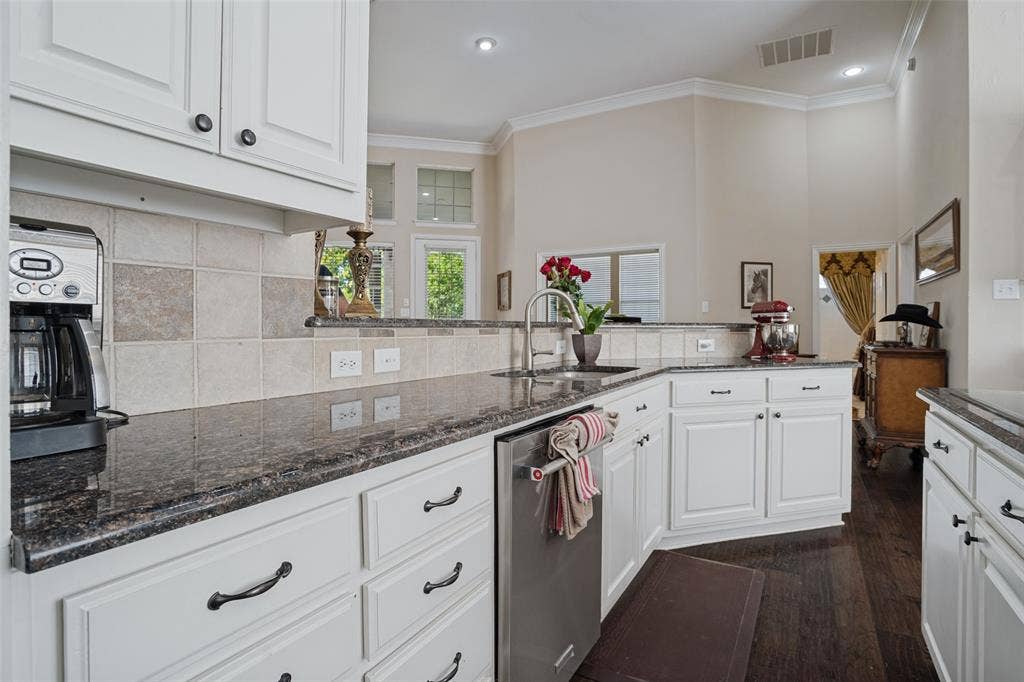 701 Crabapple Way, McKinney, TX 75072 Kitchen featuring white cabinetry, dark stone countertops, stainless steel dishwasher, square-tile backsplash, and dark wood-finish flooring