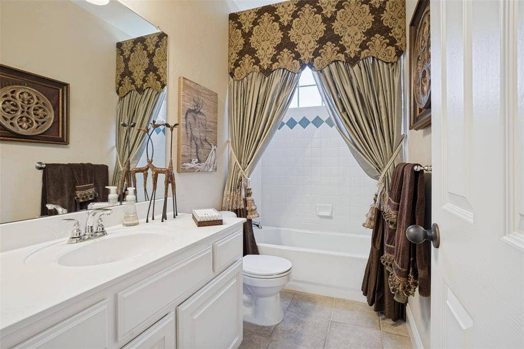 701 Crabapple Way, McKinney, TX 75072 Bathroom featuring a white vanity cabinet with an integrated sink, polished chrome faucet, large vanity mirror, tile flooring, and a tub-shower combination with tile surround