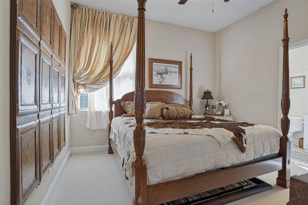 701 Crabapple Way, McKinney, TX 75072 Neutral-toned carpeted flooring, wall-mounted decorative wood paneling, and a ceiling fan