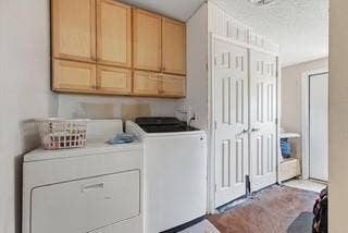 866 Old Church Rd, Waxahachie, TX 75165 Laundry area featuring light-finish wood cabinetry, dual-panel closet doors, and hard-surface flooring