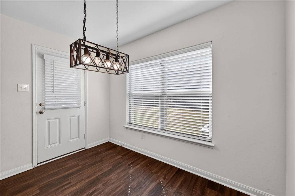 14276 Greenhaw Lane, Dallas, TX 75253 Rectangular four-light caged chandelier with a metal finish, wood-finish flooring, dual-pane window with integrated blinds, and glass-paneled exterior door