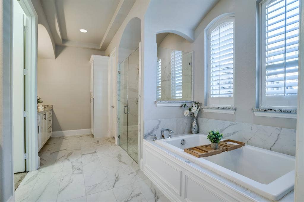 Primary bathroom with recessed lighting, a large shower, and a soaking tub