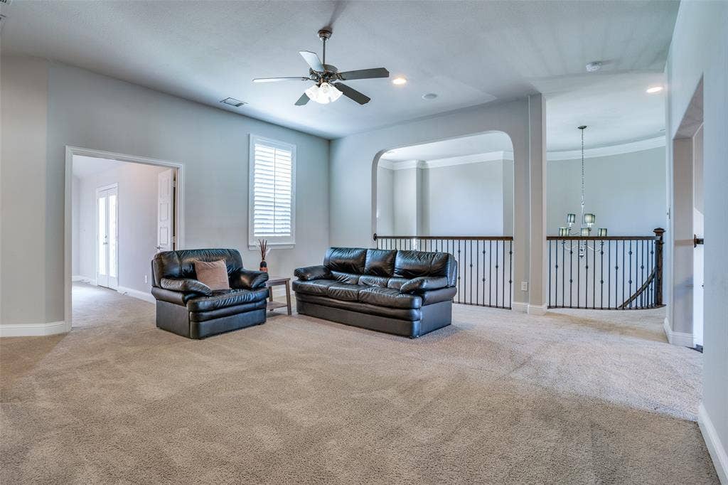 Upstairs big game room with ceiling fan