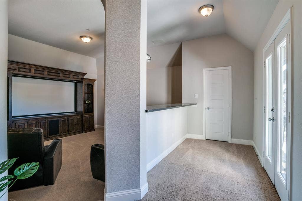 Media room with a serving bar or an eating bar with doors to the outside Juliette balcony