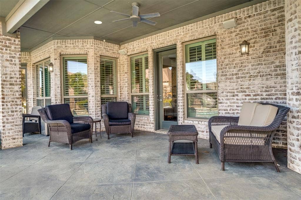 Large covered patio featuring an outdoor hangout spot and ceiling fan