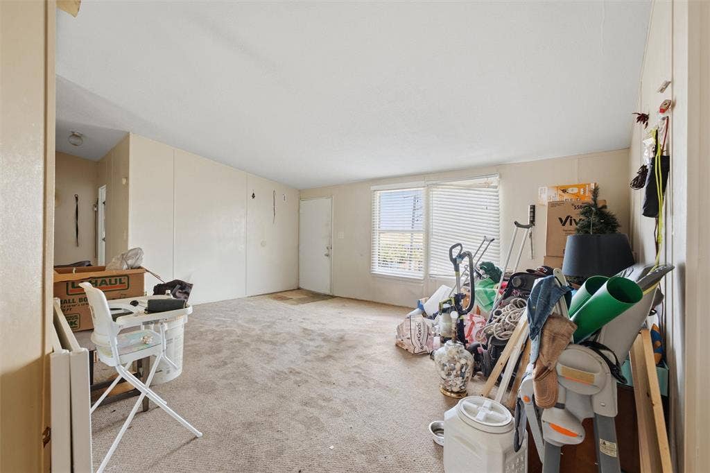 902 Old Church Rd, Waxahachie, TX 75165 Interior area featuring neutral wall paneling, carpeting, and dual windows with horizontal blinds