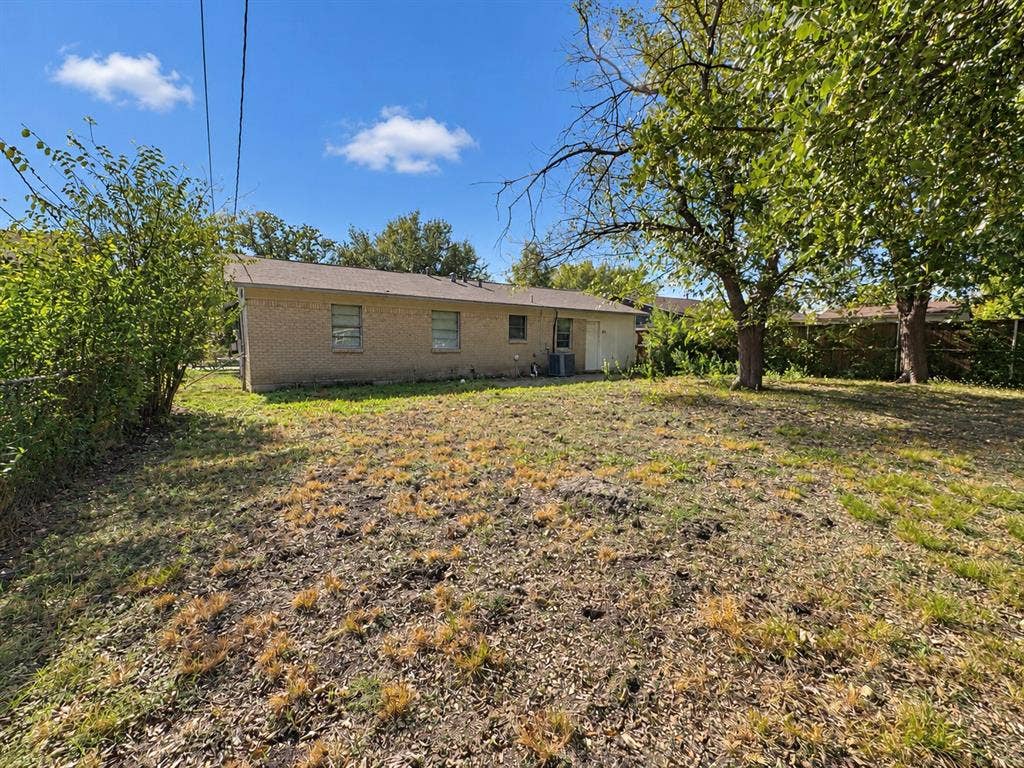 2418 Fulton Drive, Mesquite, TX 75150 Brick exterior, expansive lot with mature trees, and perimeter fencing