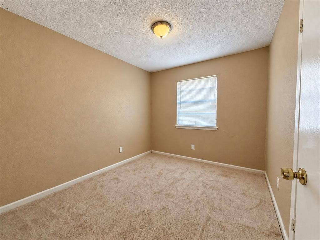 2418 Fulton Drive, Mesquite, TX 75150 Neutral wall-to-wall carpeting, textured ceiling finish, single-window illumination, and a flush-mount dome light fixture