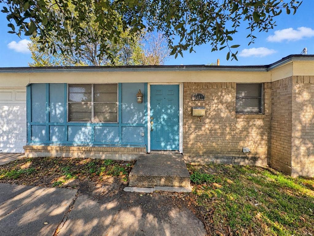 2418 Fulton Drive, Mesquite, TX 75150 Exterior facade featuring a combination of brick masonry and paneled siding, a concrete front entry pad, and an attached garage