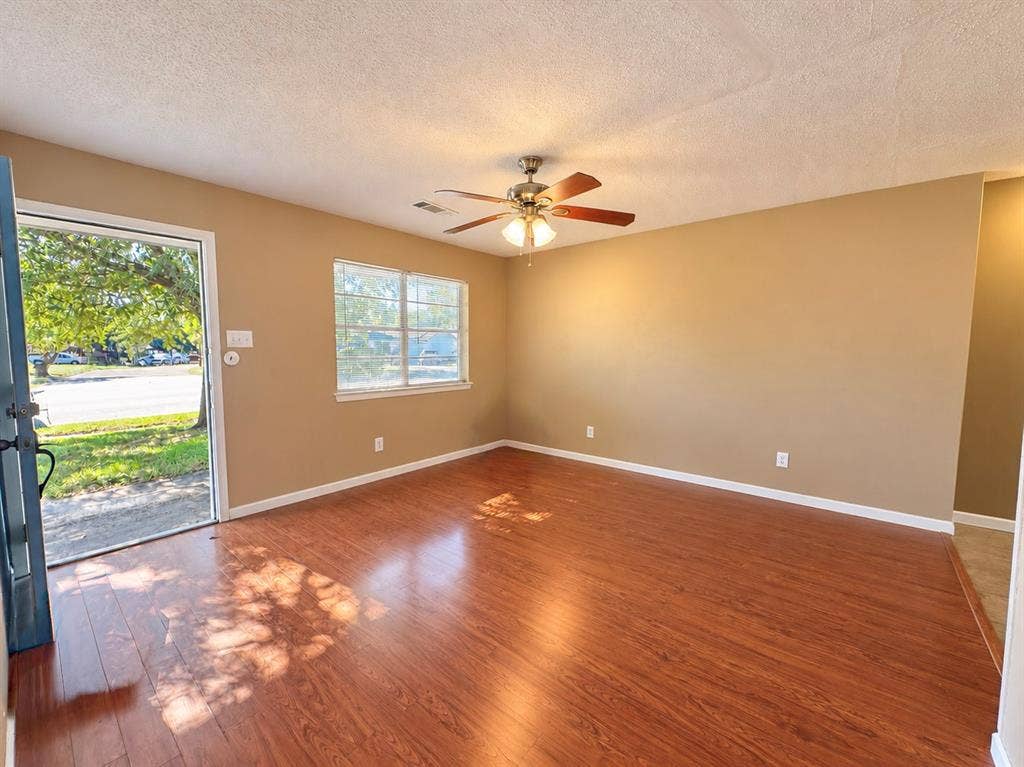 2418 Fulton Drive, Mesquite, TX 75150 Wood-finish flooring, central ceiling fan with integrated lighting, and a single-pane window