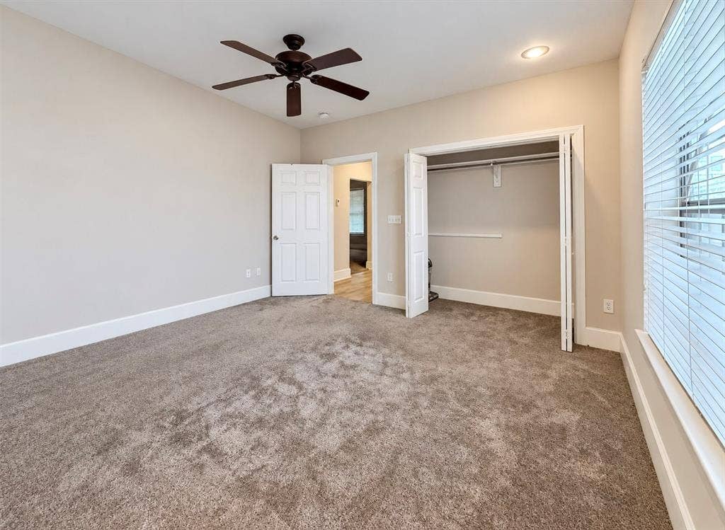 4227 Delano Place, Dallas, TX 75204 Neutral wall-to-wall carpeting, ceiling fan with light fixture, recessed lighting, and dual-panel closet with bi-fold doors