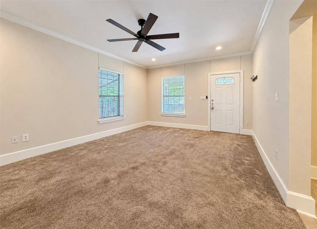 4227 Delano Place, Dallas, TX 75204 Room featuring neutral wall tones, plush wall-to-wall carpeting, recessed lighting, a matte black ceiling fan, and a paneled exterior door with a decorative glass insert