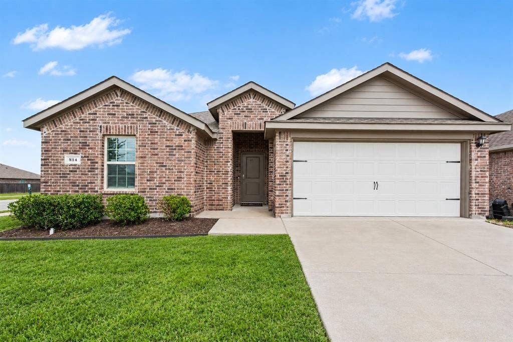 814 Rustic Meadows Trail, Princeton, TX 75407 Single-story brick exterior featuring a recessed entryway, dual-gable roofline, two-car garage, and concrete driveway