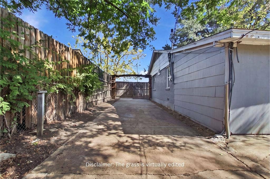 2009 S 1st Street, Garland, TX 75041 Concrete driveway with a fenced perimeter and wooden gate