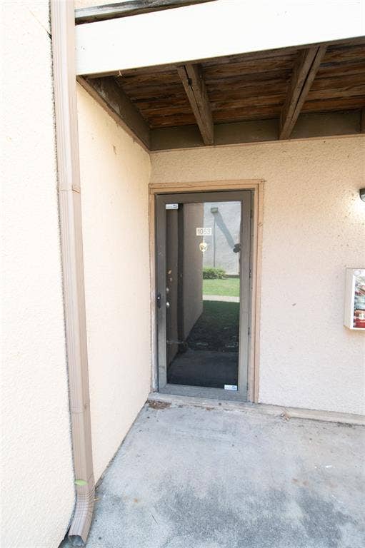 8110 Skillman Street, #1053, Dallas, TX 75231 View of exterior entry featuring stucco siding