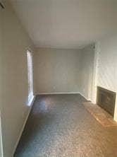 8110 Skillman Street, #1053, Dallas, TX 75231 Unfurnished living room with a fireplace with raised hearth