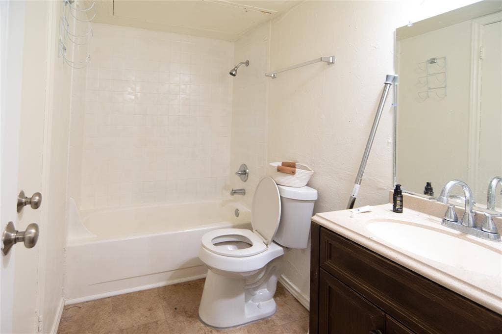 8110 Skillman Street, #1053, Dallas, TX 75231 Bathroom featuring shower combination, vanity, and light tile patterned floors