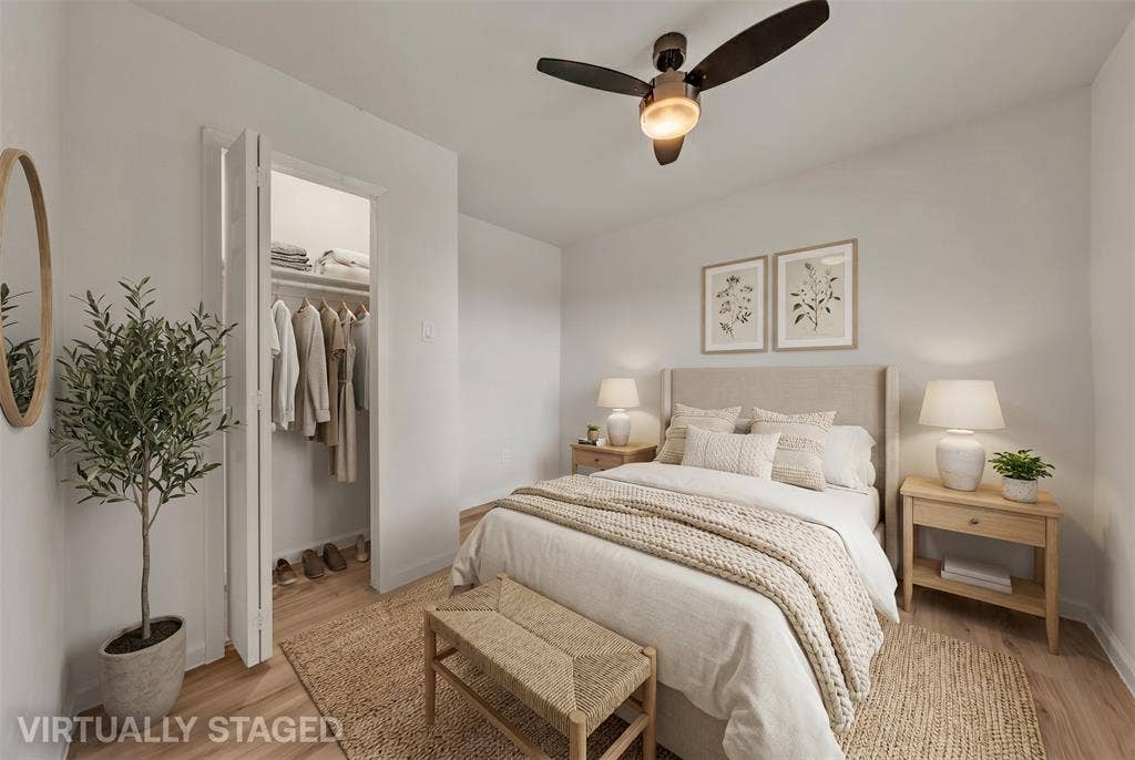 1719 Boot Hill Road, Granbury, TX 76049 Bedroom featuring wood-finish flooring, a ceiling fan with integrated lighting, and a reach-in closet with built-in shelving