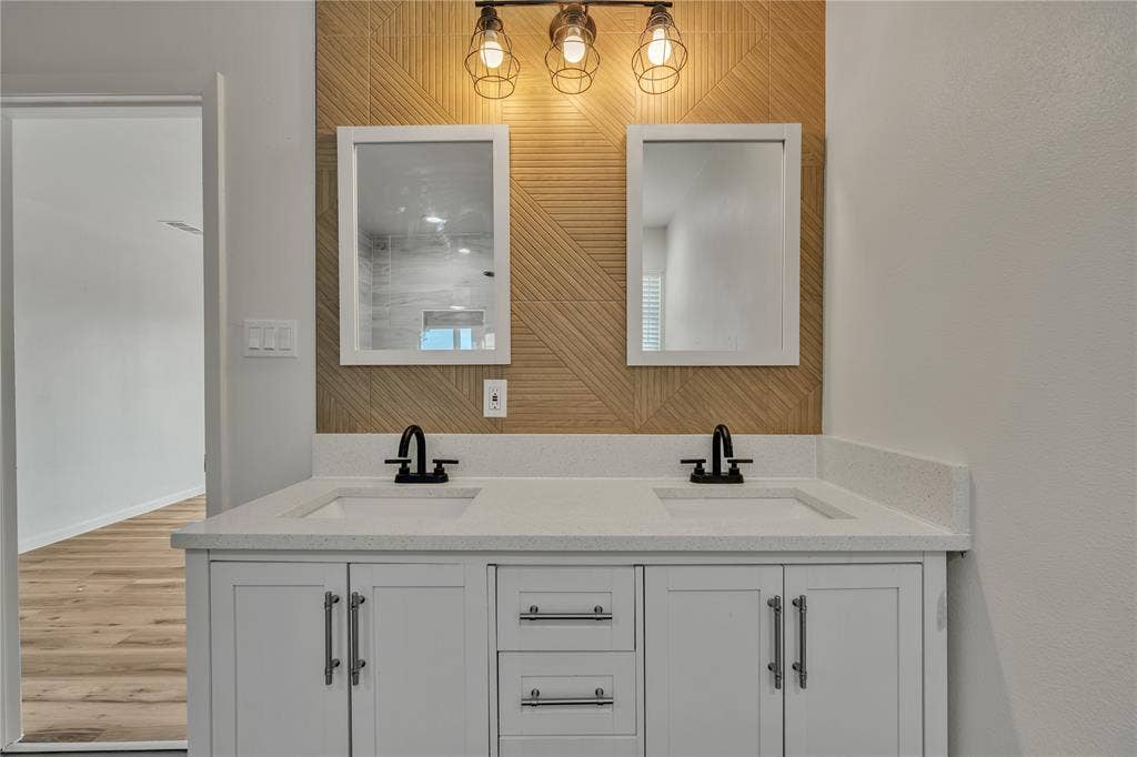 1719 Boot Hill Road, Granbury, TX 76049 Double vanity with white cabinetry, quartz countertop, dual rectangular undermount sinks, geometric tile backsplash, and matte black fixtures