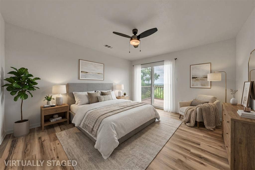 1719 Boot Hill Road, Granbury, TX 76049 Wood-finish flooring, ceiling fan with integrated lighting, and glass sliding doors providing exterior access