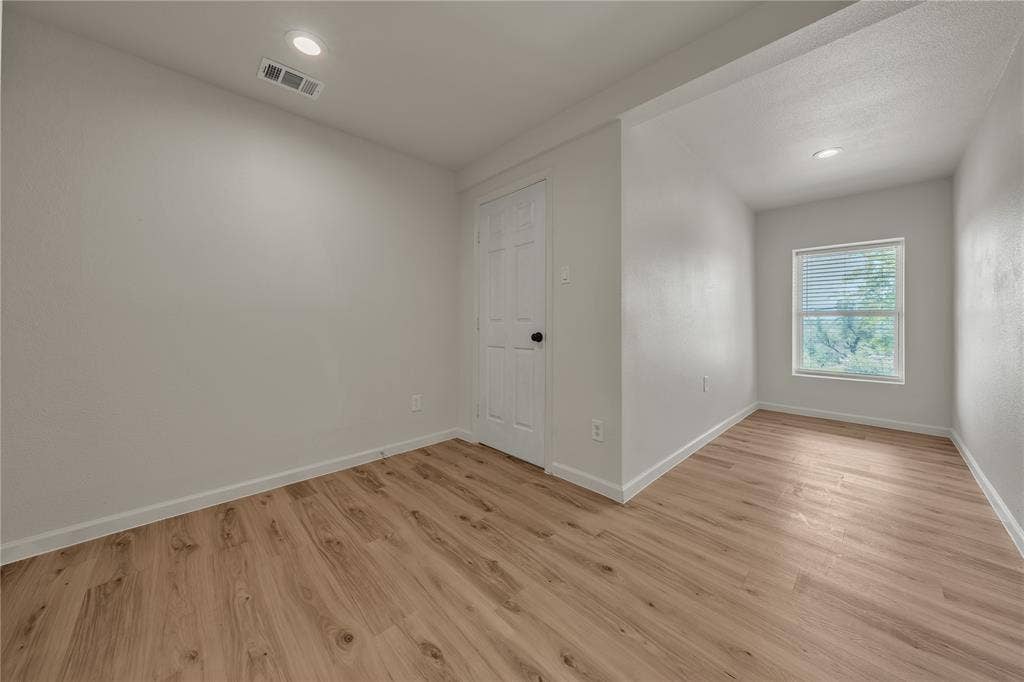 1719 Boot Hill Road, Granbury, TX 76049 Interior room featuring light-toned wood-finish flooring, recessed lighting, and a six-panel door