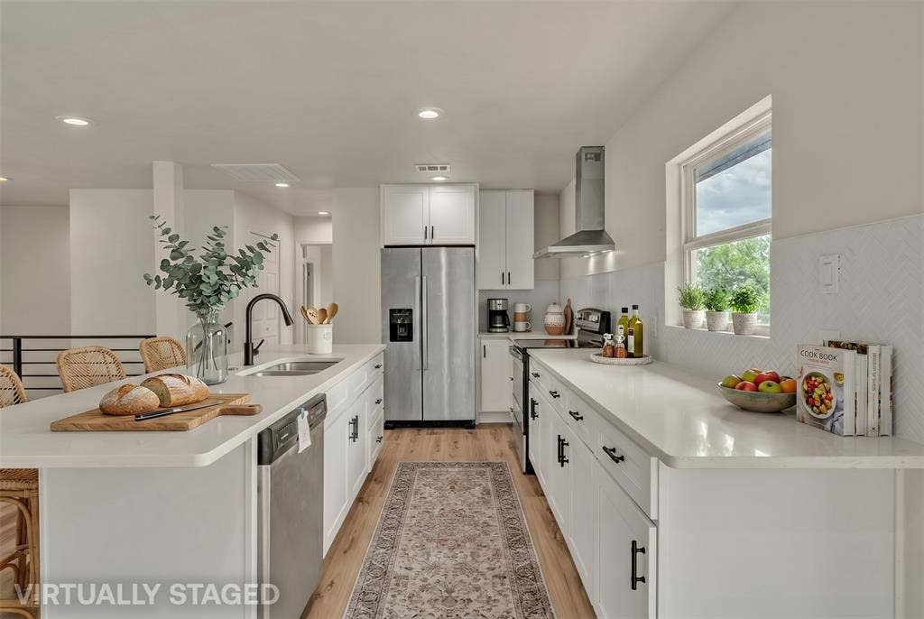 1719 Boot Hill Road, Granbury, TX 76049 Kitchen featuring white cabinetry, solid-surface countertops, stainless steel appliances, a range hood, and wood-finish flooring
