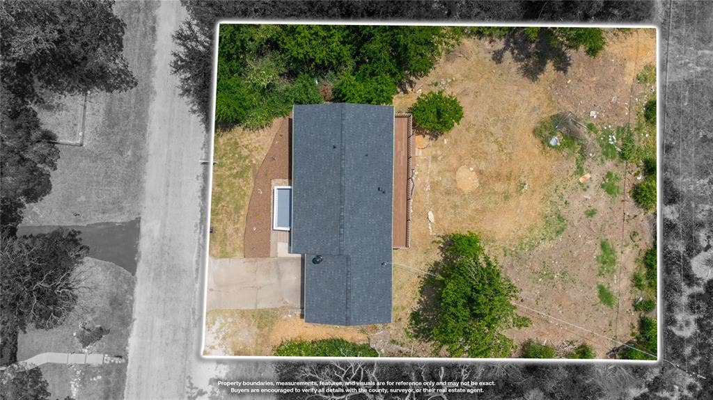 1719 Boot Hill Road, Granbury, TX 76049 Aerial perspective of property featuring an expansive lot, mature trees, a roof with shingle finish, a concrete driveway, and an elevated wood deck