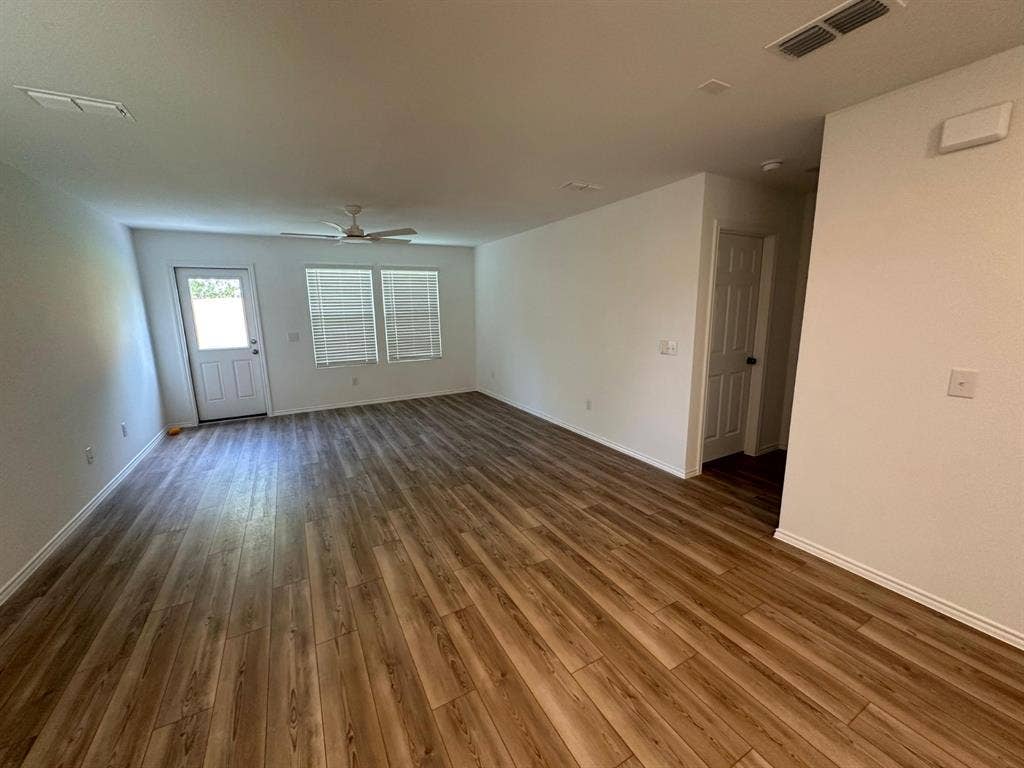 821 POPPY COVE Lane, Princeton, TX 75407 Interior space featuring wood-finish flooring, a ceiling fan, a multi-pane exterior door, and neutral wall tones