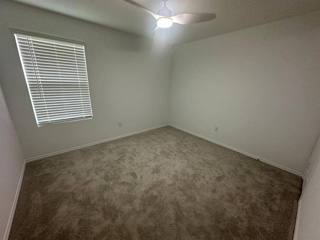 821 POPPY COVE Lane, Princeton, TX 75407 Neutral wall color, wall-to-wall carpeting, window with blinds, and ceiling fan with integrated lighting