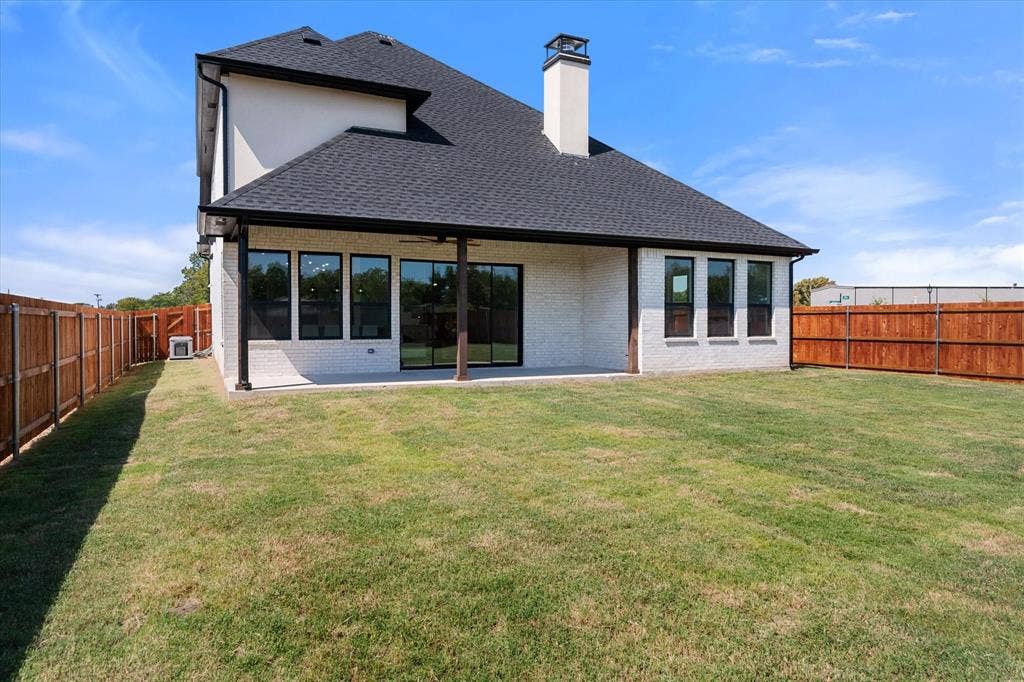 122 Yvonne Street, Red Oak, TX 75154 Back exterior featuring a covered patio, stained fence