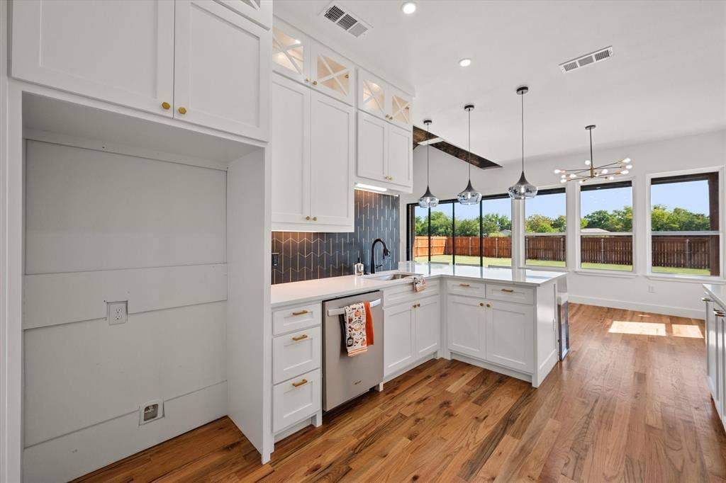 122 Yvonne Street, Red Oak, TX 75154 Kitchen features Whirlpool appliances-dishwasher, pendant lighting and under counter lighting